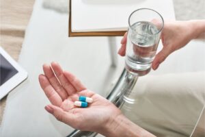 woman takes a dose of her antidepressant medication
