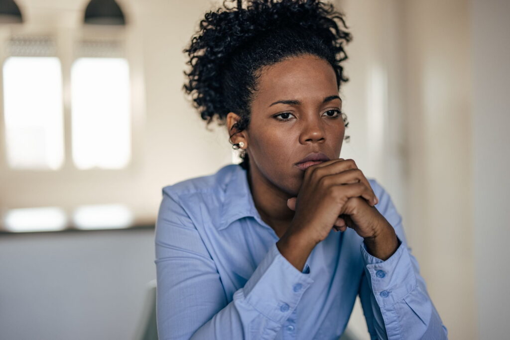 worried woman with an anxiety disorder sits alone